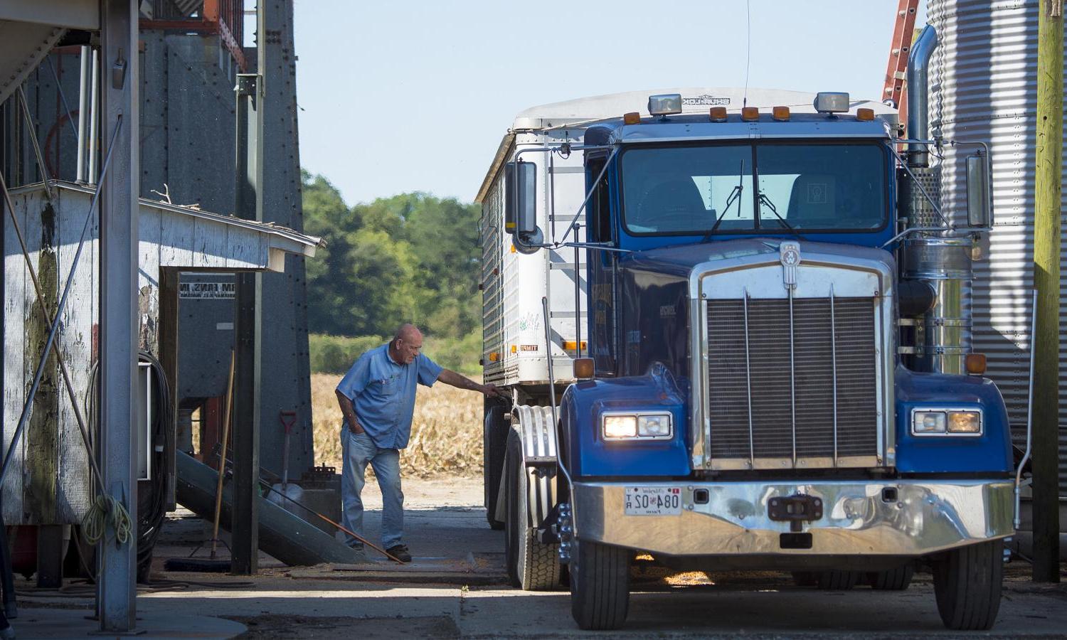 Person working on freight truck.